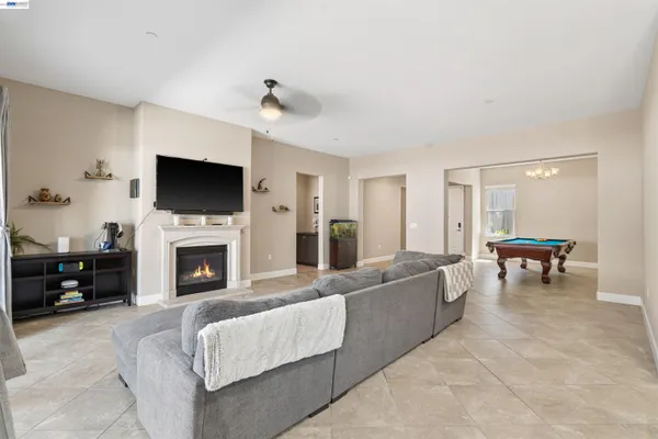 a kitchen with stainless steel appliances granite countertop a table chairs sink refrigerator and microwave