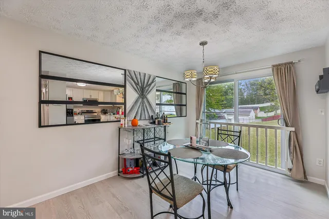 a dining room with furniture garden view and a chandelier