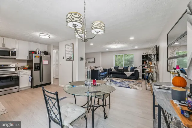 a view of a dining area with furniture and a kitchen