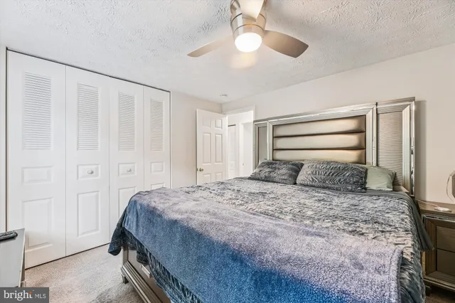 a bedroom with a large bed and a chandelier