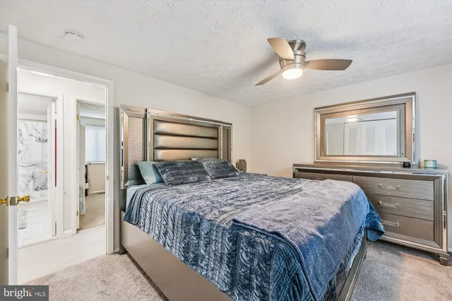 a bedroom with a bed and a large mirror