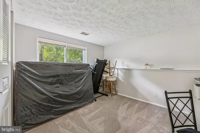 a bed sitting in a room next to a window