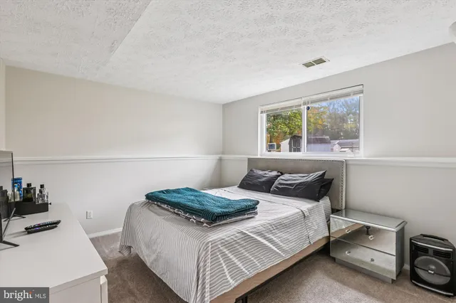 a bedroom with a bed and a television