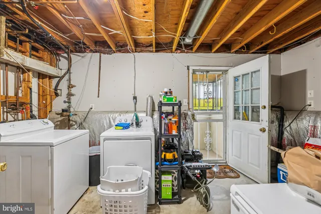 a view of a white house with a yard