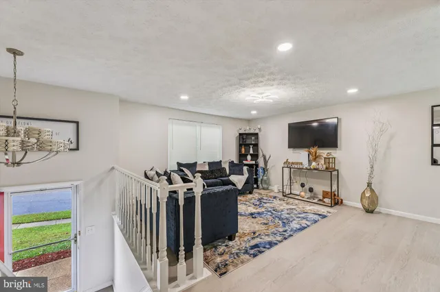 a view of a livingroom with furniture and a flat screen tv