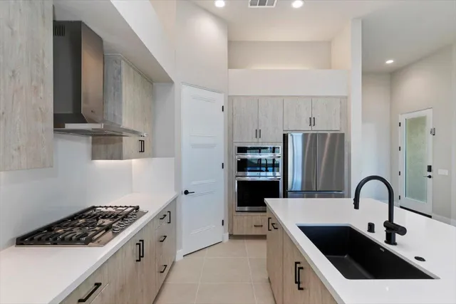 a kitchen with stainless steel appliances kitchen island a white stove a sink and a refrigerator