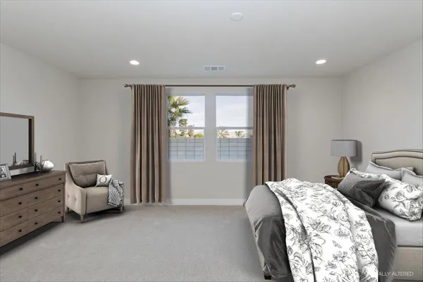 a bed room with a bed and a chair