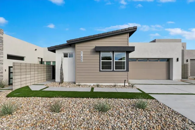 a front view of a house with garage