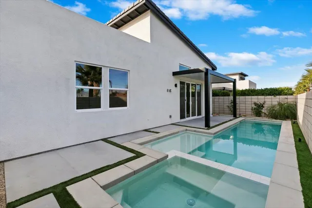 a view of an house with backyard and porch