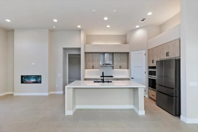 a kitchen with kitchen island white cabinets and stainless steel appliances