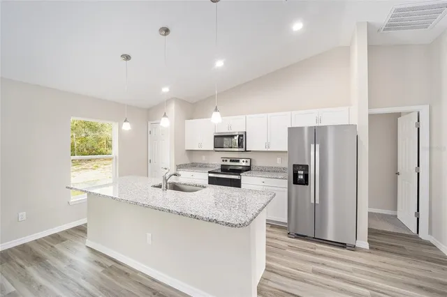 a kitchen with refrigerator and microwave