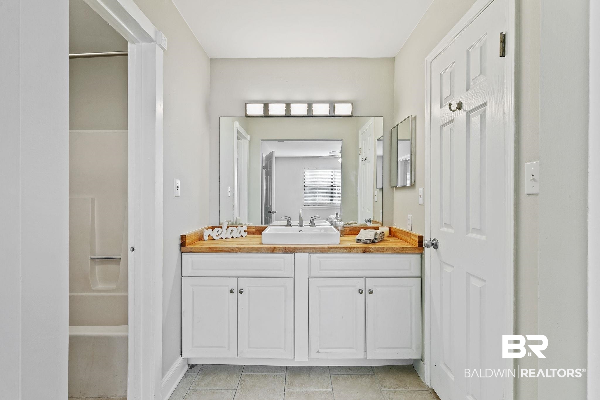 110 5th Street, Unit C103 Daphne, AL 36526 - Photo 33 of 46 Bathroom with tile patterned floors and vanity