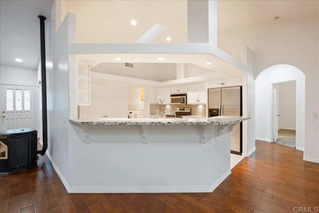 9144 Old Castle Road Valley Center, CA 92082 - Photo 11 of 48 a large kitchen with kitchen island a sink stainless steel appliances and a counter top space