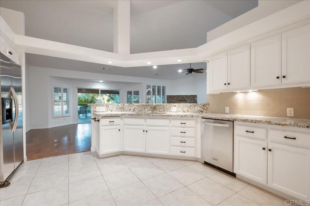 9144 Old Castle Road Valley Center, CA 92082 - Photo 13 of 48 a kitchen with granite countertop white cabinets and sink