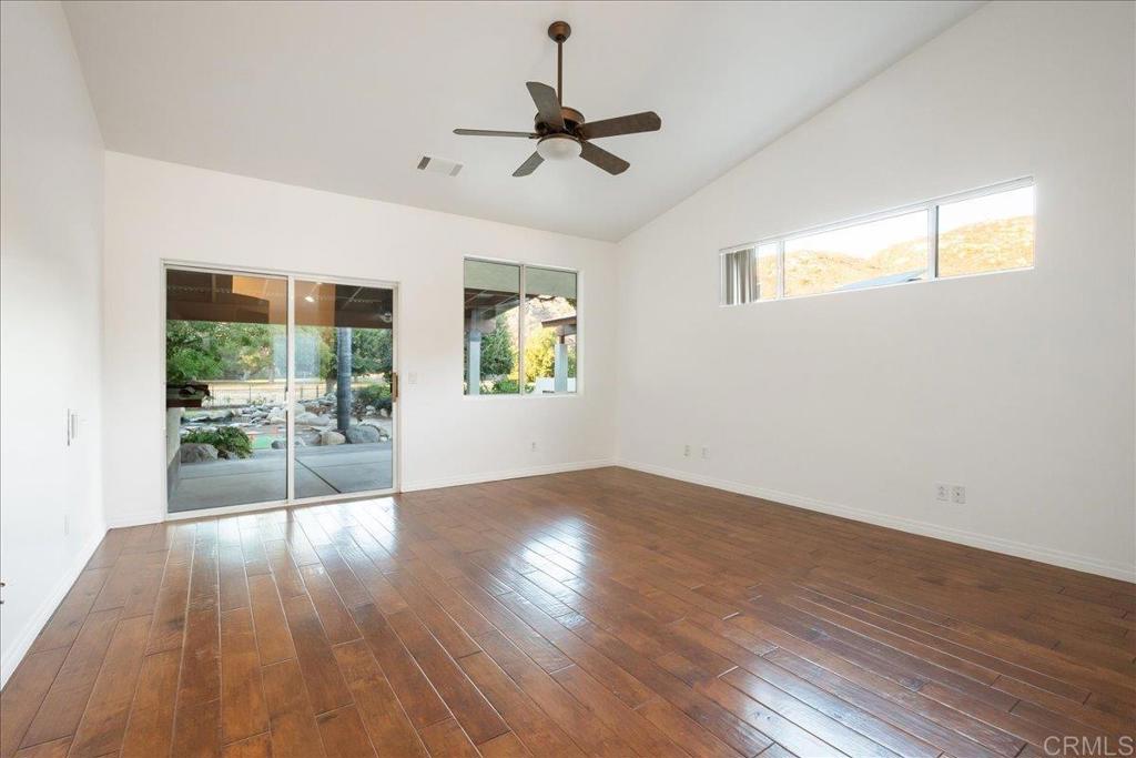 9144 Old Castle Road Valley Center, CA 92082 - Photo 18 of 48 a view of empty room with wooden floor and fan