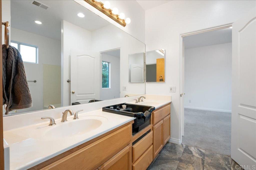 9144 Old Castle Road Valley Center, CA 92082 - Photo 25 of 48 a bathroom with a sink and a mirror