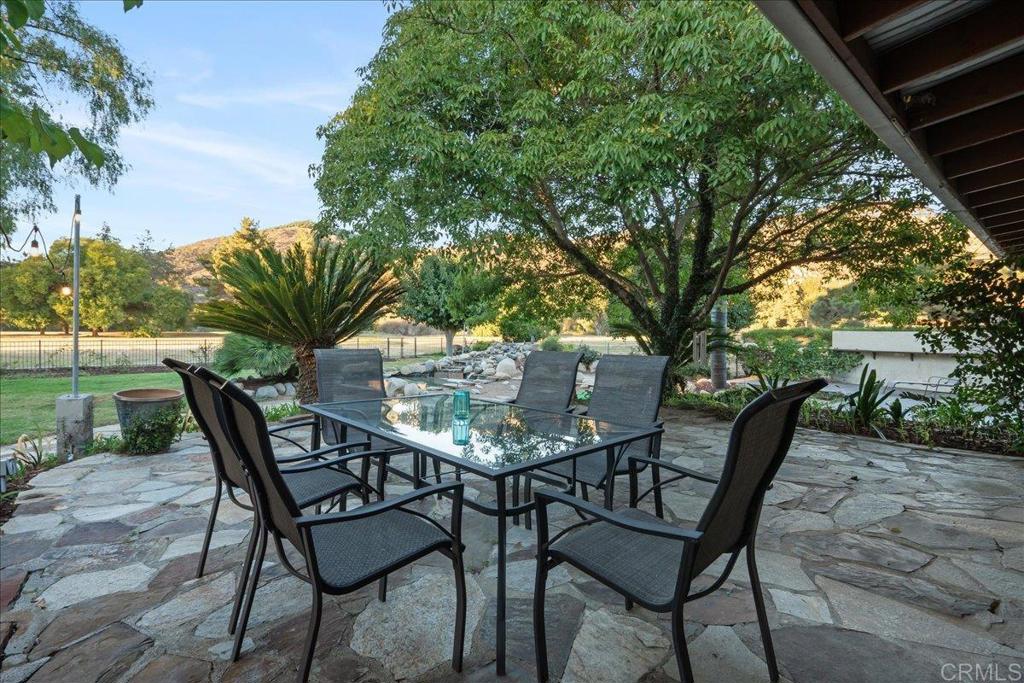 9144 Old Castle Road Valley Center, CA 92082 - Photo 29 of 48 a patio with table and chairs and potted plants with large tree