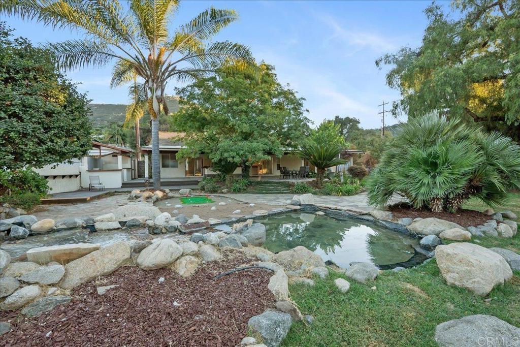 9144 Old Castle Road Valley Center, CA 92082 - Photo 32 of 48 a backyard of a house with a yard and outdoor seating