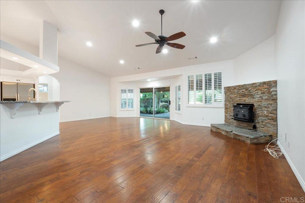 9144 Old Castle Road Valley Center, CA 92082 - Photo 4 of 48 a view of empty room with wooden floor and fireplace