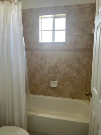 a bathroom with a bathtub and shower