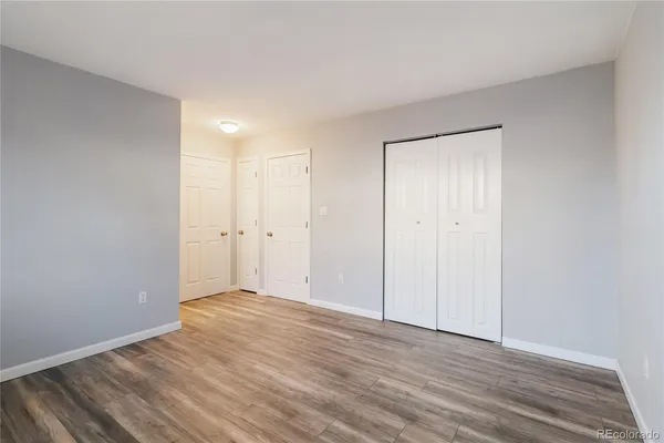 a view of an empty room with wooden floor
