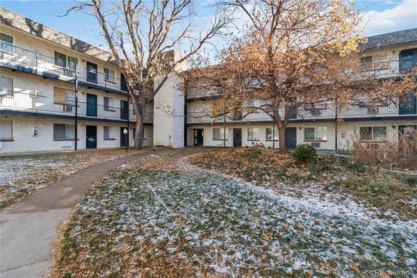 a front view of a residential apartment building with a yard