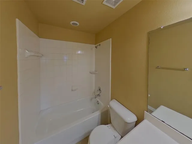 a bathroom with a toilet and a bathtub