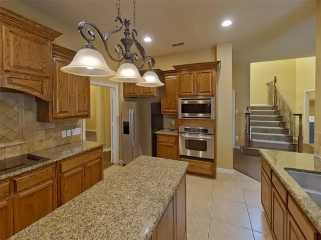 a kitchen with stainless steel appliances granite countertop a sink and cabinets
