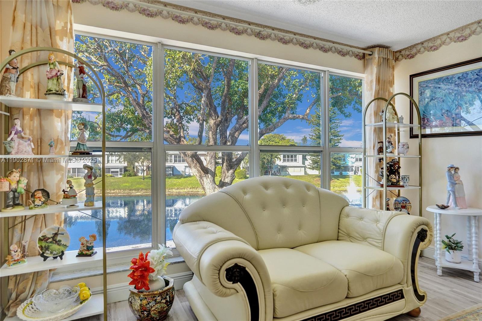 1450 Northwest 18th Avenue, Unit 203 Delray Beach, FL 33445 - Photo 11 of 30 a living room with furniture and a floor to ceiling window