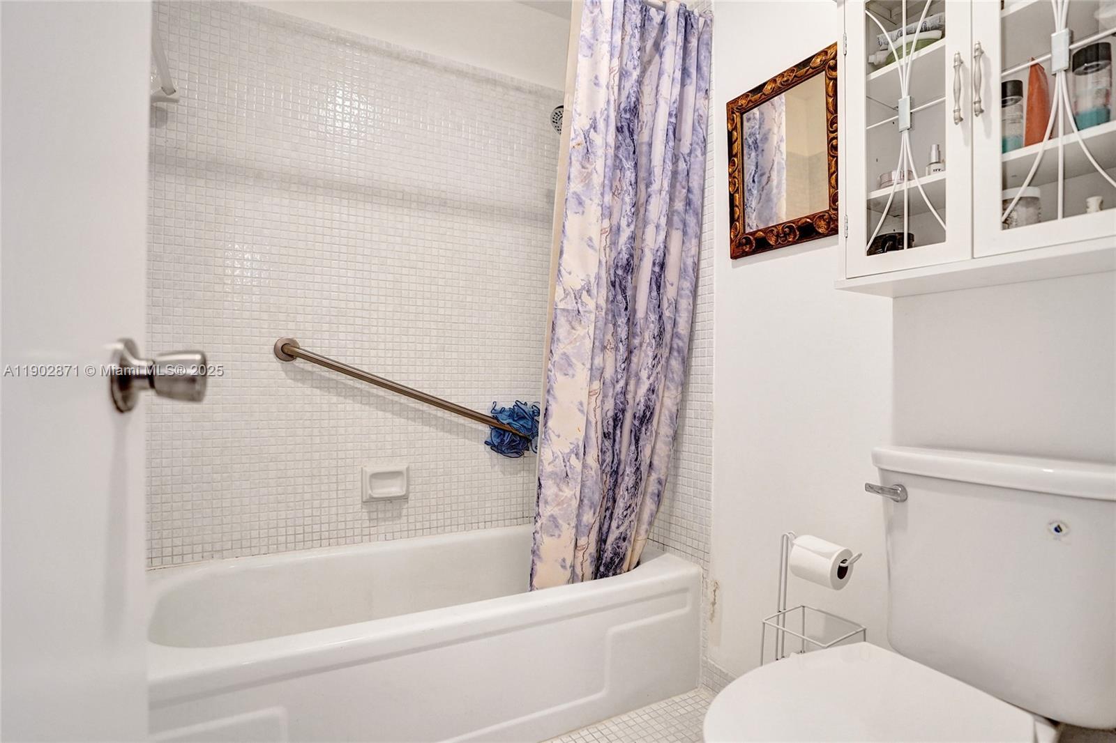 1450 Northwest 18th Avenue, Unit 203 Delray Beach, FL 33445 - Photo 19 of 30 a bathroom with a toilet and a bathtub