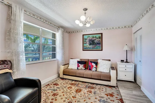 a living room with furniture and a baby crib