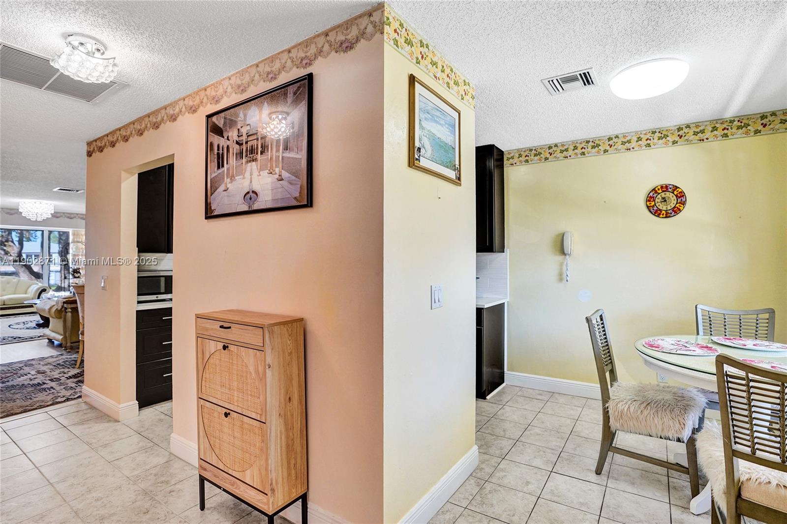 1450 Northwest 18th Avenue, Unit 203 Delray Beach, FL 33445 - Photo 2 of 30 a view of a hallway with furniture and front door