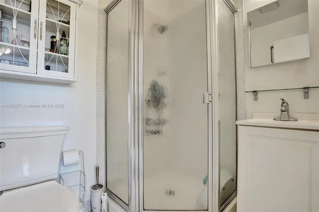 a bathroom with a shower a toilet and sink