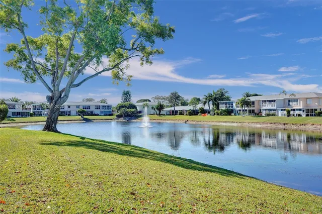 a view of swimming pool with outdoor seating and lake view