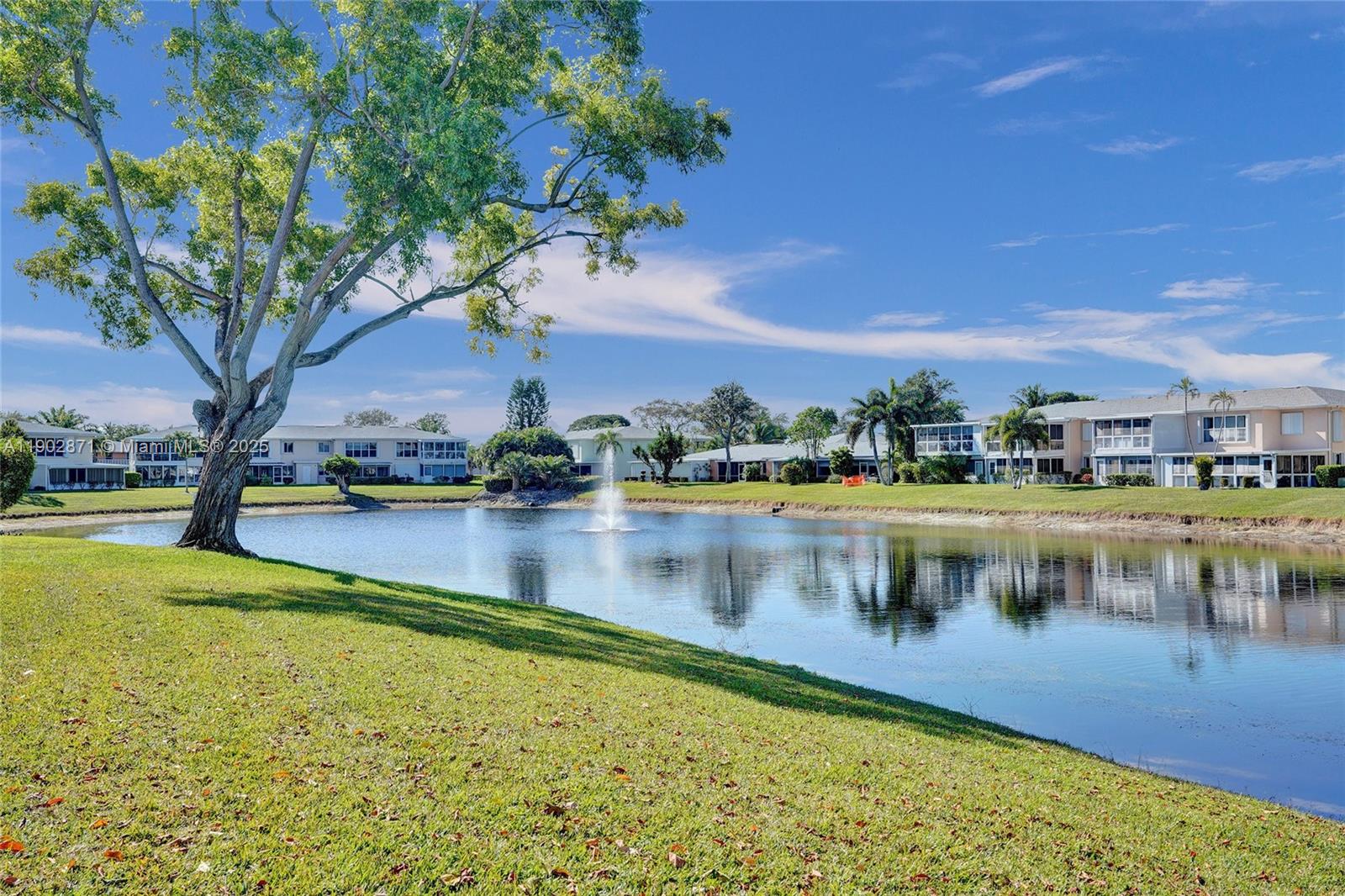 1450 Northwest 18th Avenue, Unit 203 Delray Beach, FL 33445 - Photo 23 of 30 a view of swimming pool with outdoor seating and lake view