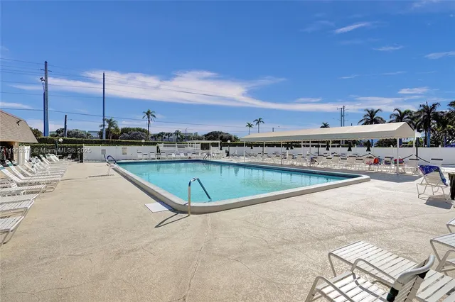 a view of a swimming pool with a lounge chairs