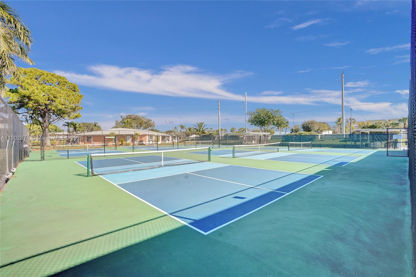 1450 Northwest 18th Avenue, Unit 203 Delray Beach, FL 33445 - Photo 26 of 30 a view of a tennis court