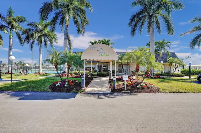 a view of a park with a bench and trees