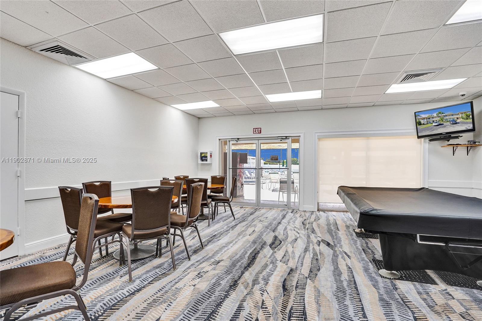 1450 Northwest 18th Avenue, Unit 203 Delray Beach, FL 33445 - Photo 28 of 30 a view of a dining room with furniture