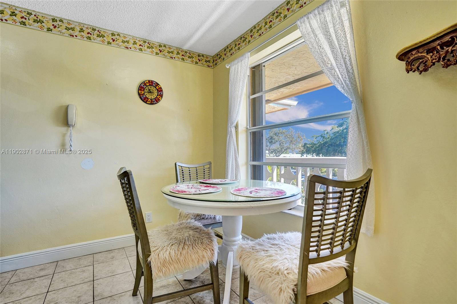1450 Northwest 18th Avenue, Unit 203 Delray Beach, FL 33445 - Photo 3 of 30 a view of a dining room with furniture and wooden floor