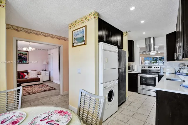 a kitchen with refrigerator a sink and cabinets