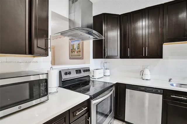 a kitchen with cabinets and stainless steel appliances