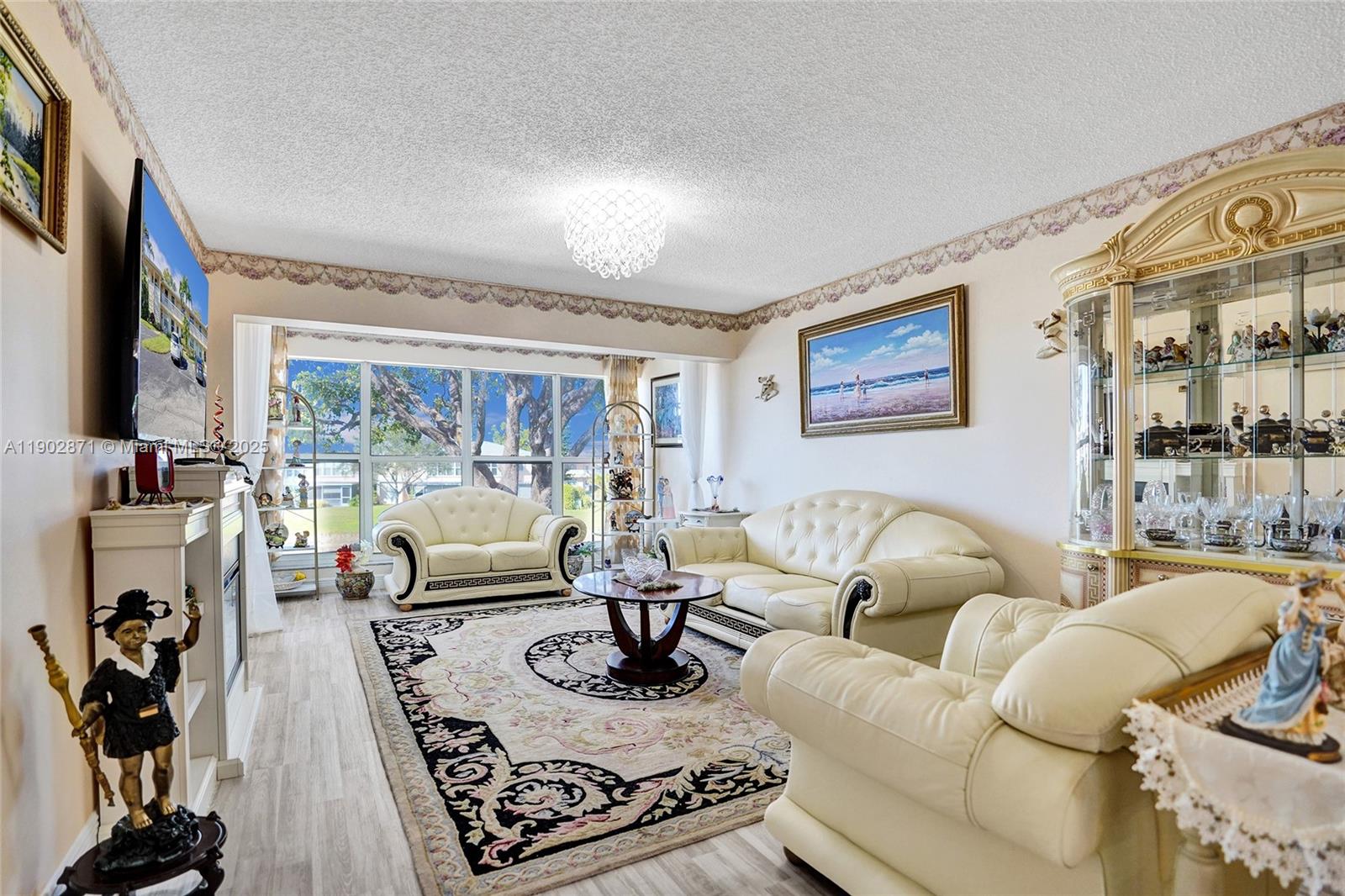 1450 Northwest 18th Avenue, Unit 203 Delray Beach, FL 33445 - Photo 9 of 30 a living room with furniture fireplace and a flat screen tv
