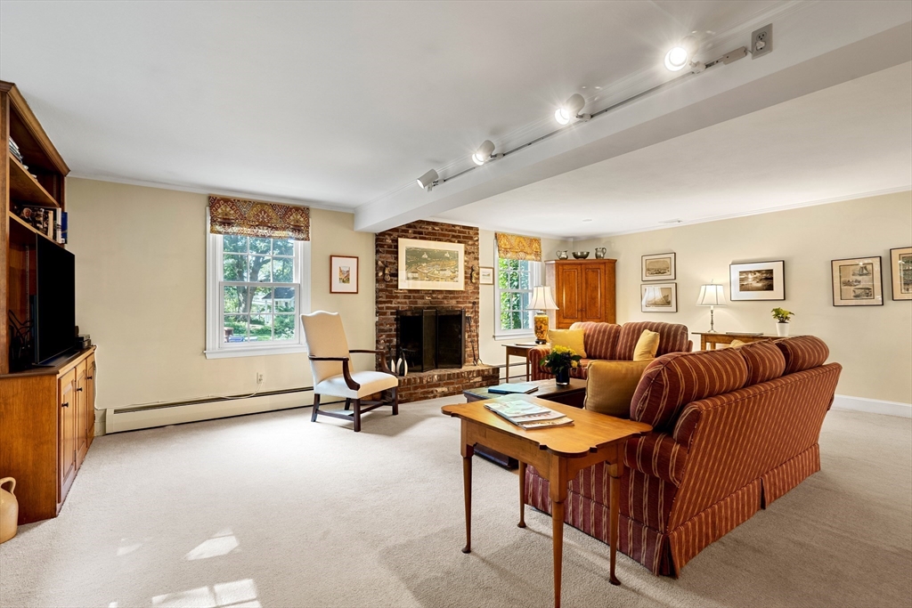 5 Crestwood Road Marblehead, MA 01945 - Photo 11 of 28 a living room with furniture a flat screen tv and a fireplace