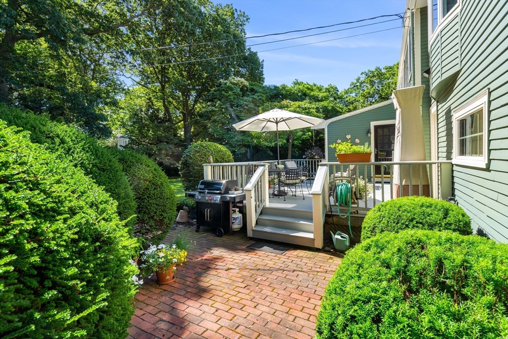 5 Crestwood Road Marblehead, MA 01945 - Photo 24 of 28 a view of a patio with table and chairs under an umbrella with a small yard