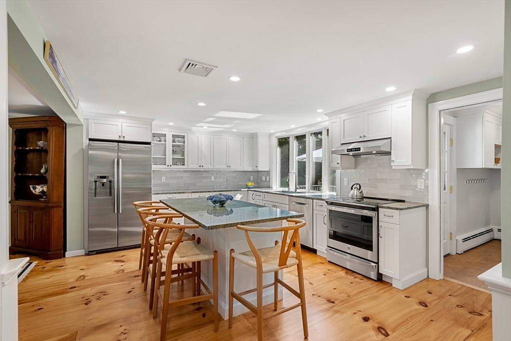 5 Crestwood Road Marblehead, MA 01945 - Photo 5 of 28 a kitchen with stainless steel appliances granite countertop a stove a refrigerator a oven a sink with a dining table and chairs