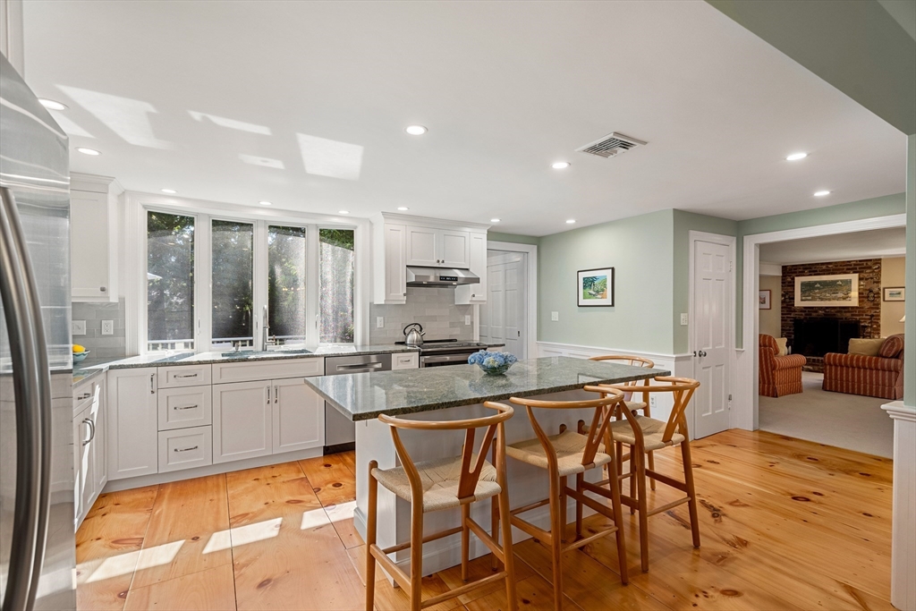 5 Crestwood Road Marblehead, MA 01945 - Photo 7 of 28 a kitchen with stainless steel appliances granite countertop table chairs and wooden floor
