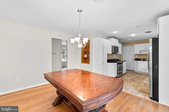 a room with kitchen island a stove and a refrigerator