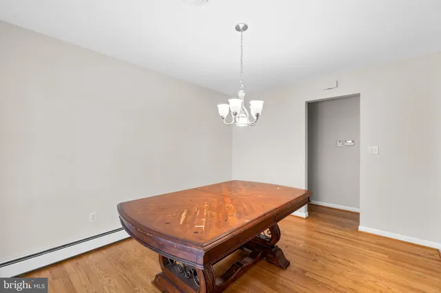 a room with pool table and wooden floor