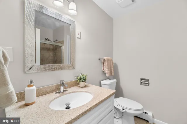 a bathroom with a sink toilet and mirror